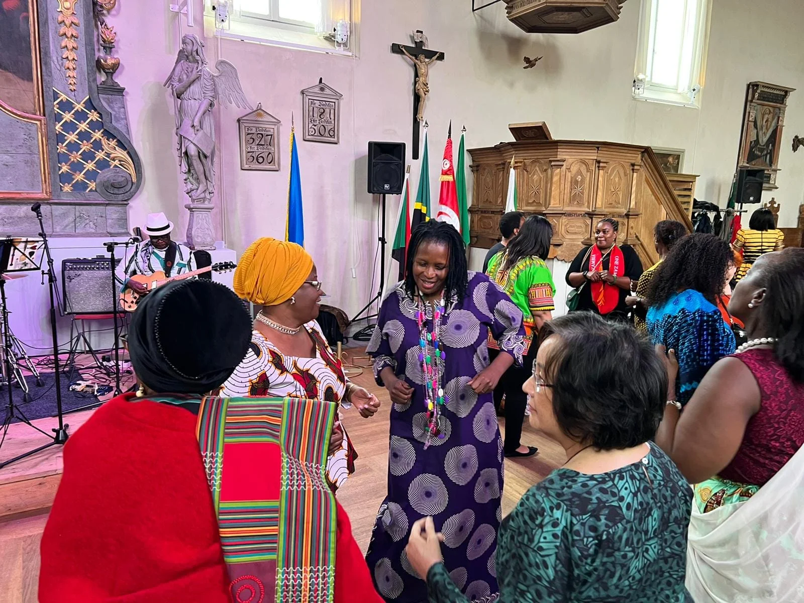 Guests in colourful dress gathered in the hall
