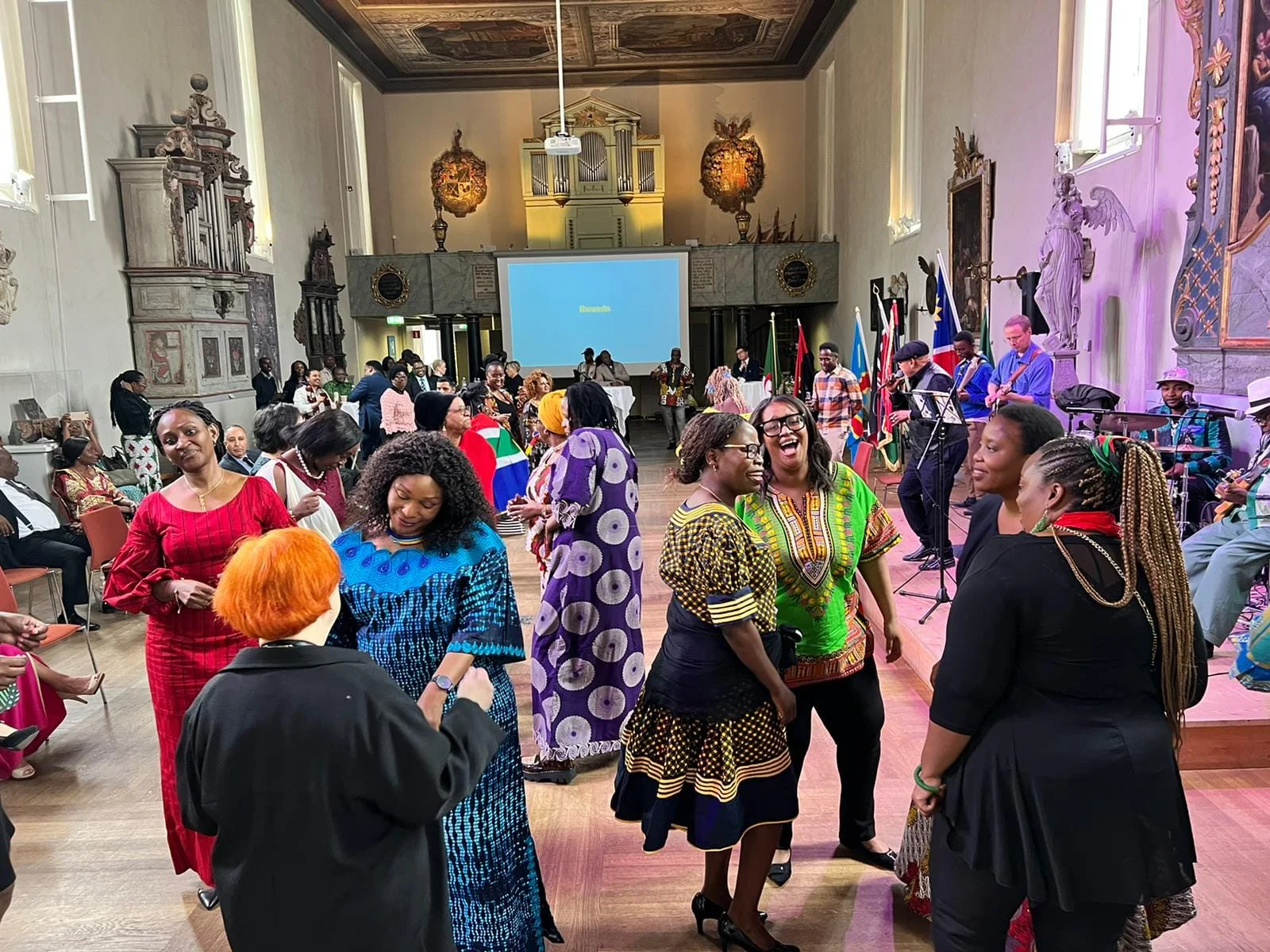 Guests dancing in front of a screen