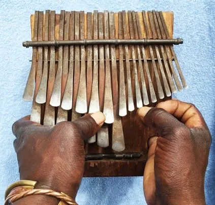 Hands playing an mbira