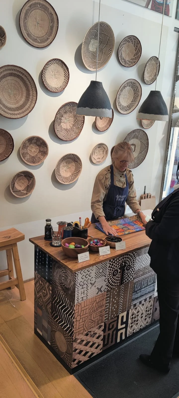 A wall of woven baskets and plates in the shop