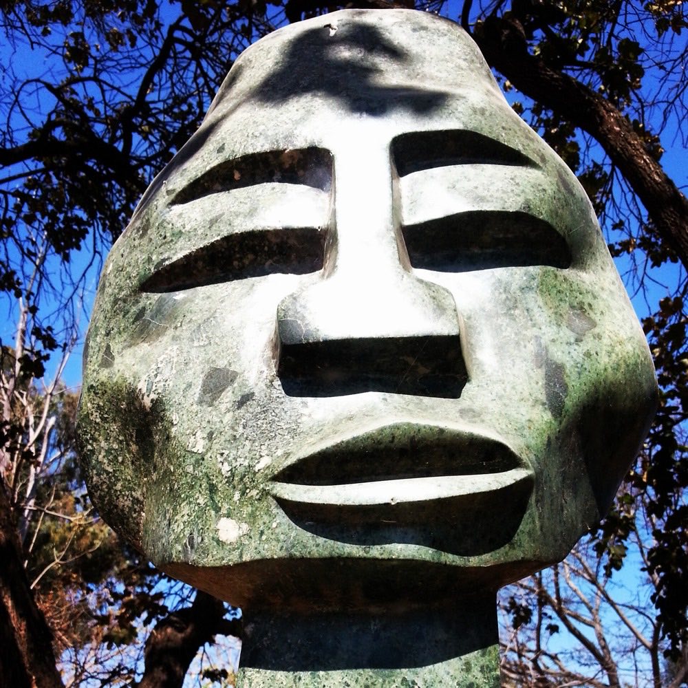 A carved stone head sculpture